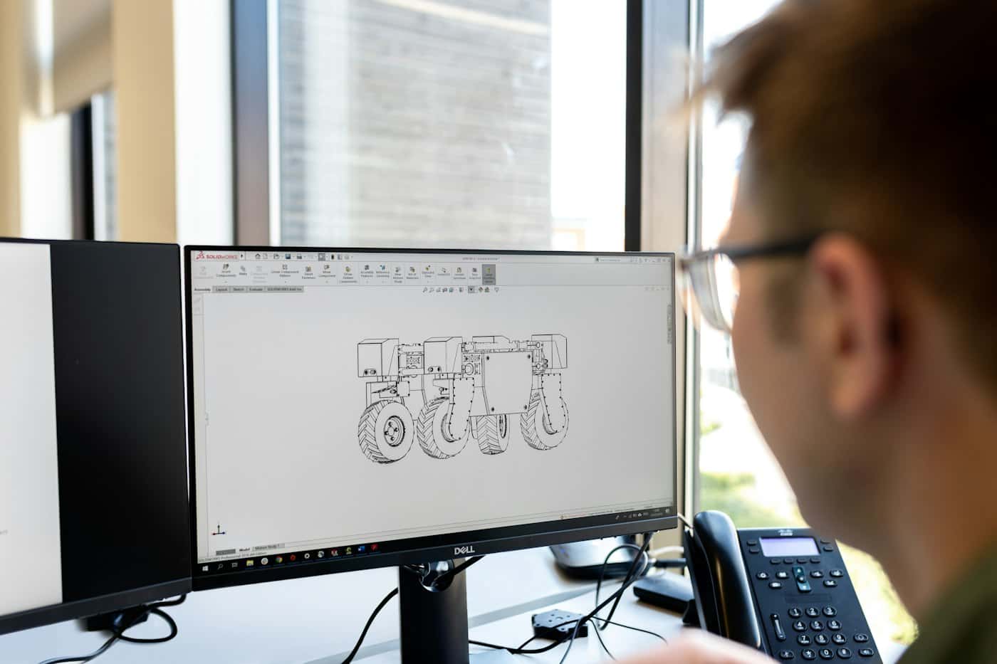 Engineer reviewing a detailed digital model at a workstation