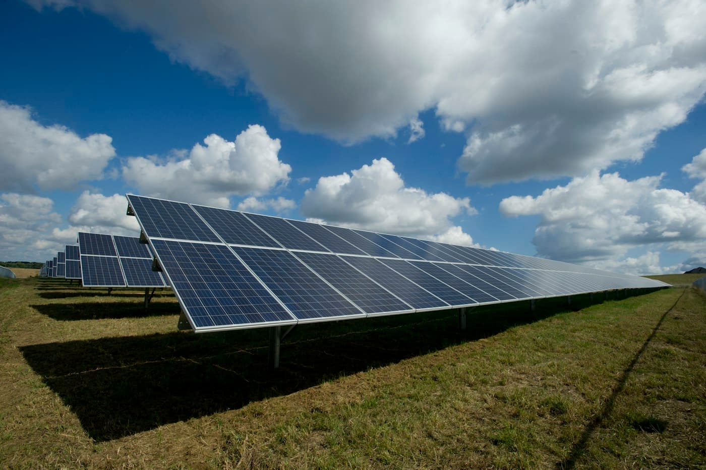Solar photovoltaic panels beneath a cloudy sky